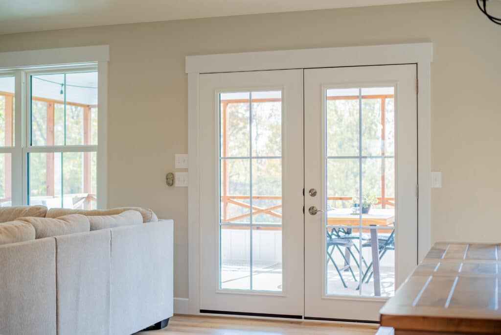 Legacy French door with internal grids leading to a screened in porch.